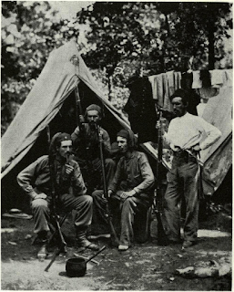 Warlike quartet of Yankee nicotine addicts relaxes in camp of New York Zouaves by leaning on their Long Enfields. 