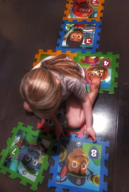 Paw Patrol playmats being assembled into a Hopscotch by a young girl