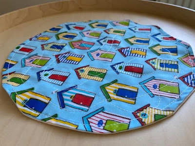 Small round fabric placemat with beach hut fabric