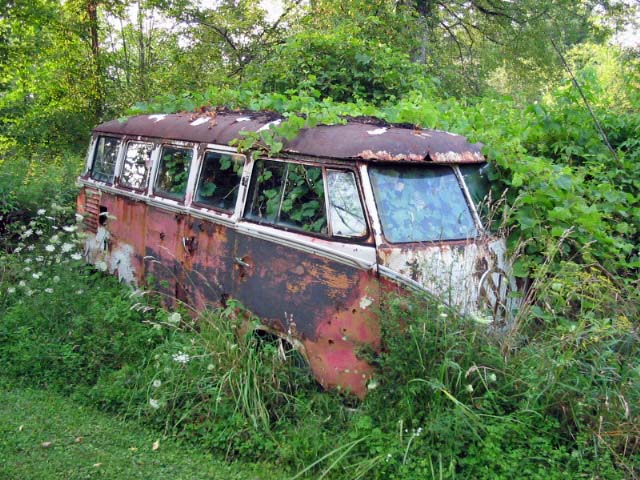 Abandoned hippie van and old bus
