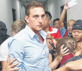 JAILED: Dutch national Dylan Snel (centre) leaving a court hearing along with three other hikers in Kota Kinabalu on June 12. The four took naked photos of themselves at the summit plateau of Mount Kinabalu.