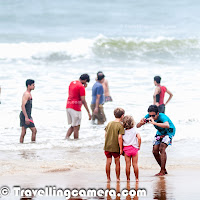 This monsoon, I was in Goa and loved driving around different parts of North & South Goa. Baga Beach was quite interesting place among different things we explored around the beautiful Goa.  Baga Beach is a popular beach and tourist destination with various options for tourists in North Goa. This Photo Journey shares some of the elements of Baga Beach which makes it different from other beaches in Goa.Baga Beach is located in north part of Goa and situated at one end of the contiguous beach stretch which starts from Sinquerim, Candolim & Calangute... Next to Baga is Anjuna Beach which also one of the popular beaches in North Goa. Baga beach has  a series of shacks, fishing boats, Water-sports options, some of the brilliant restaurants for sea food and high tides... We were staying near Candolim Beach and the day started by driving to Anjuna beach, which are disappointing during Monsoons. It was completely shut-down.. There was no eating place to have breakfast and overall space was dirty.. Black sand on the beaches made thing worse. Soon after we made our mind to move towards  Baga Beach. On reaching Baga Beach, the search for a good restaurant started. There are lot of options on the beach with nice views of the sea. Here we took the wise decision to call Dev to ask for recommended options to eat. We had hired a WagonR from Dev and he recommended us to visit Brittos for having Goan Sea-Food. And I must say that it was awesome. We had Crabs and Prawns at Brittos with some Coconut Feni. The best part was seating arrangement at Brittos. Most of the tables are aligned in such a way that guests get a nice view to the Baga beach, which remains full of tourists, most of the time. This is one of the most crowded beach of North Goa. Calangute is another over-crowded beach in Goa. Monsoon is considered as off season in Goa and during Monsoons, Calangute was very crowded.While sitting at Brittos, we didn't want to leave our seats as it was giving beautiful views of the beach by being under a shed. Most of the photographs used in this Photo Journey are shot while sitting at Brittos at Baga Beach. We had multiple orders at Brittos, since we didn't want to leave the seats. At that point of time, I couldn't appreciate the taste of Feni so ordered beer in subsequent rounds :). While enjoying the sea food at Brittos, we observed different vendors selling stuff to tourists at the beach. The photograph on the left shows the lady vendor who was selling trinkets on the beach. We observed that almost everyone negotiated with lady, but she sold to 80% of the folks who negotiated. These observations made us think that negotiation is must and followed the same rule while went to the beach. We bought 3 things from the lady at 30% of the original cost quoted. Although we realized that the absolute amount paid was much higher than what is asked in the Baga market :).We observed many of the tatoo artists roaming around the beach and asking tourists to choose appropriate designs to be tatooed on their bodies. These were all temporary tatoos and having a tatoo in Goa is a popular trend and most of the folks prefer to have one or more Tatoos in Goa. We observed max number of Tatoo artists at Baga Beach and the other beach was Calangute, where we met few Tatoo Artists. During the visit, we met a very creative Tatoo Artist, who is considered as one of the best Tatoo artists who was honored by Goa Tourism as well. We shall do a separate story on David, along with his special Tatoo designs & celebrities, who chose him to create tatoos for them.  Most of the tourists at Baga Beach love to have a comfortable place to sit & enjoy the awesome environment which is difficult to find in other parts of the world. While having food at Brittos, we overheard that dolphins can also be located at around 5 kilometers from the shoreline, but we forgot to confirm this fact. The name of the beach has come from Baga creek, which empties into the Arabian Sea at the northern end of the beach. On the beach there are options for tourists to have head/foot massage while enjoying your drink on beach-side.Baga beach is also a popular beach for Parasailing, Watersports and Dolphin cruises. During Monsoons, there was hardly anything to do on the beaches but most of the folks prefer to have fun with high tides of the sea and their friends. we observed some of the beach-restaurants playing loud music. The photograph on the left shows a group of tourists having fun in music and water waves of the sea. There were many such groups at Baga Beach and this is pretty different from any other beach in North Goa. All other beaches have restaurants at distance and there were hardly any shacks during monsoons. If you plan for Goa and want to have a good time on a lively beach with water sports, then Baga beach is a good option for you and you must visit it. Although, at the same time, my personal favorite was Candolim beach, because of the type of crowd this beachgets, not so crowdedness and relatively peaceful to have some private space on the beach-sand. If you opt for Baga Beach, then you must compromise on beach cleanliness and crowd quality... There are plenty of shacks at Baga, but only a few are good, so choose carefully. Sitting on a laid back beach seat, enjoying the sun set while sipping cocktails is a must! Many of the families also come of this beach and some large tourists can be seen around the beach. This photograph shows the jeeps on beach which ensure that tourists don't go to the danger zone of the sea and be safe. They used to warn folks going inside the sea and many times, one or two folks used to go & bring people back. These jeaps were there on almost every beach, except Candolim. We saw those at Calangute & Miramar as well. Baga Beach in north Goa may be touristy and busy but for those who like action, it’s one of the most happening beaches on the coast. It's a place for party lovers and many of the options that a tourist wants in Goa. Although water-sports were not available during the monsoons but it seems that parasailing & watersports are quite cheap at Baga Beach, but quality should be expected on same parameters. Overall experience may becomeworthwhile if you are ready to pay more to the folks offering those services.Finally we had a walk around the beach and chose to leave for Calangute. Most of the time was spent at a restaurant which exposed us to different activities happening on beach and now it was time to move on... More Photo Journeys from Goa will follow soon...