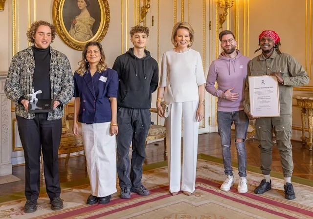 Queen Mathilde wore a white top by Natan, and white trousers by Natan. Sezane gold leaf earrings. I See, Idea, I do