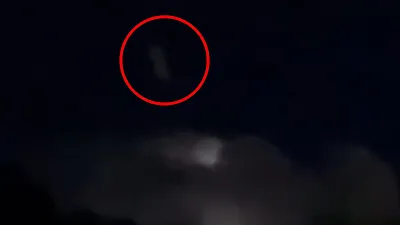 White rectangular shape UFO object exits the cloud during lightening thunderstorm.
