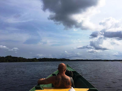 Alex in the prow of the boat on Juma Lake