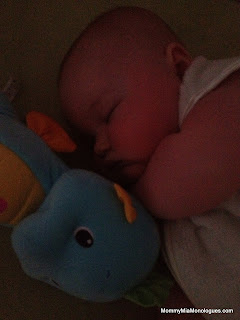 baby snuggled with soothe and glow seahorse