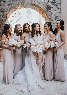 bride smiling with bridesmaids in grey