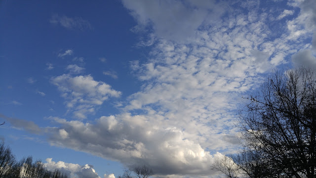 White whispy clouds in blue sky