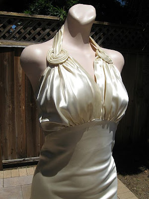 A 1940s vintage wedding gown has a satin hand sewn circular motif at the 