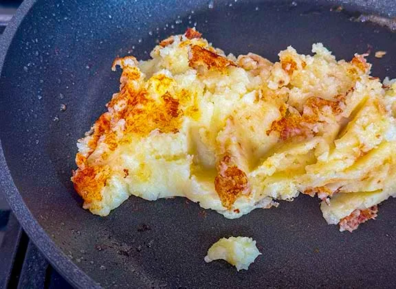 Making pan fried mashed potatoes.