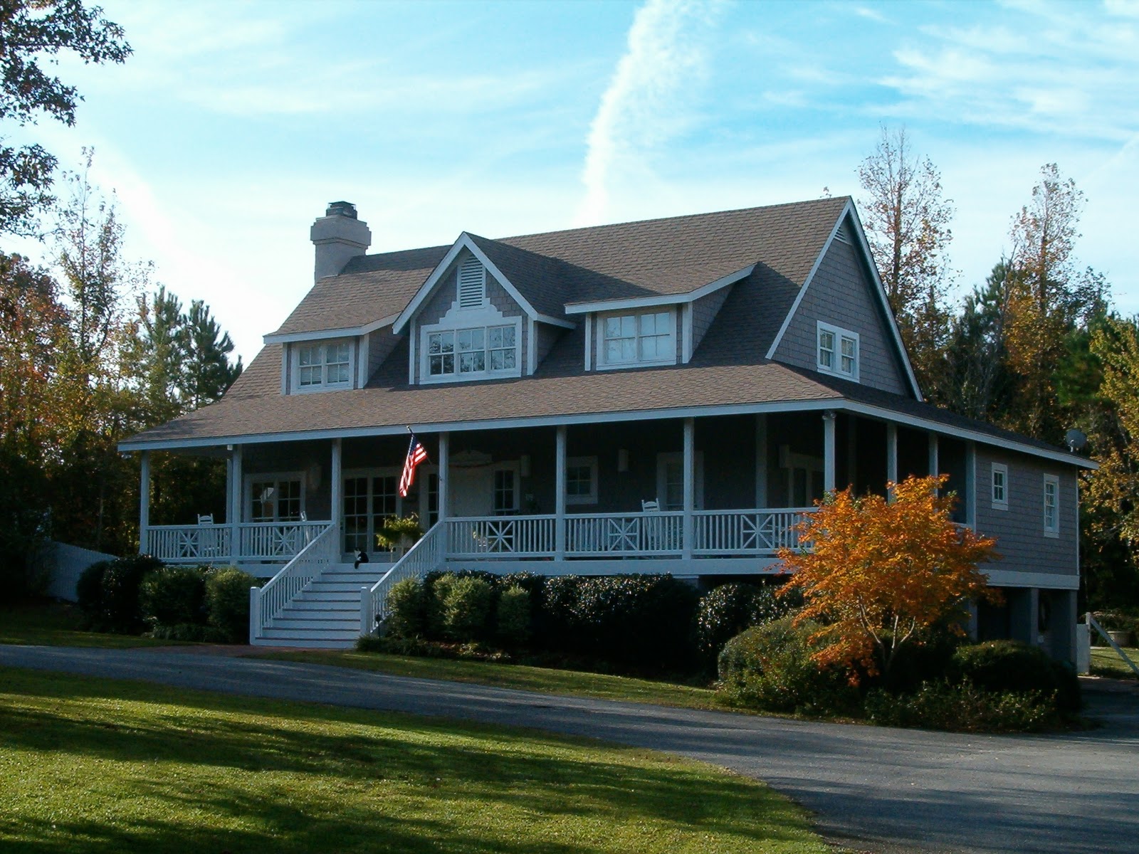  and features large, wrap-around porches and a full basement title=