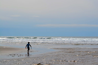 photo of boy playing on Rockaway Beach by Nancy Zavada