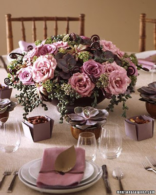 Centerpiece 1 in purples and browns with roses succulents and fern curls 