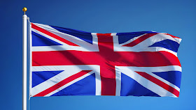 Pic of UK's flag flying at top of flagpole against clear blue sky 
