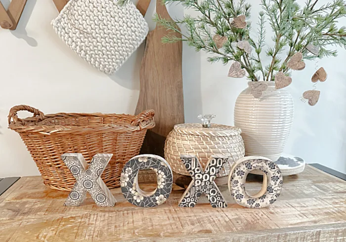 X's and O's on a shelf with a basket