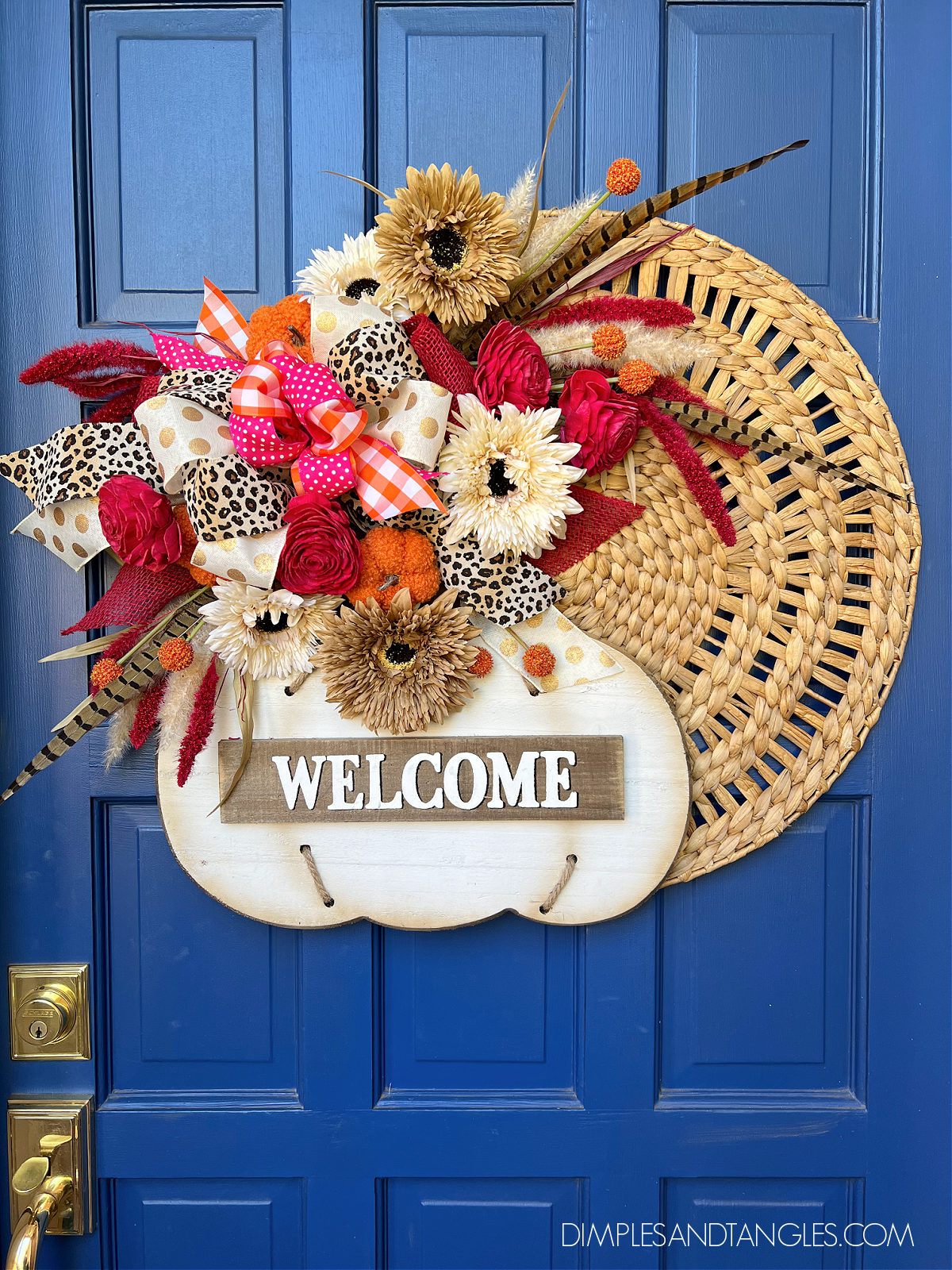 Round Woven Wall Hanger with wood pumpkin attached, layered with faux fall flowers and leopard, gingham, and polka dot bows