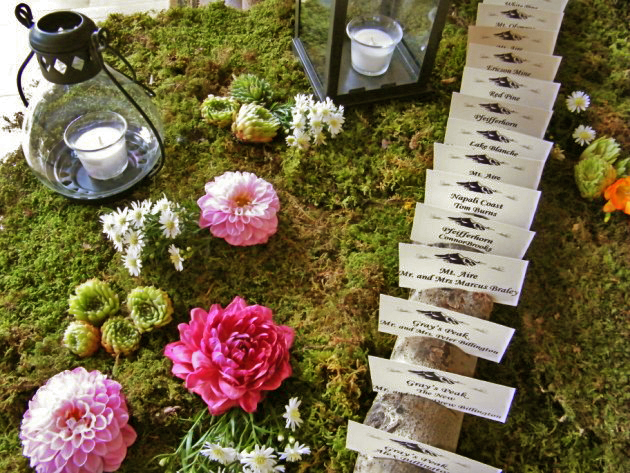 Moss flowers and aspen card holders led the way inside after the ceremony