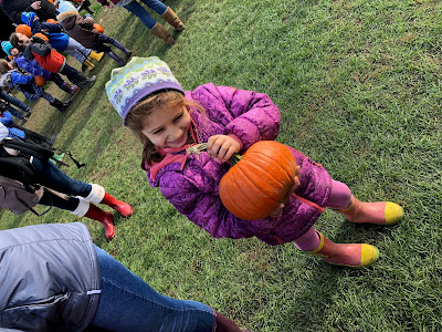 girl holding pumpkins