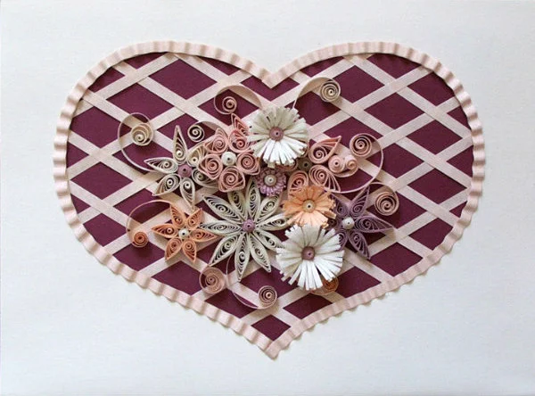 rectangular cream color valentine with cut out heart shape that is filled with woven paper strips and quilled flowers in shades of cream, peach, and pink