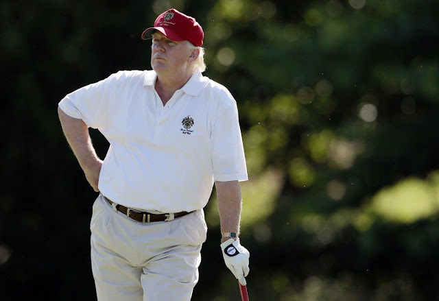 Trump visits his Florida golf course as families bury school shooting victims just miles away