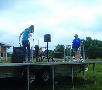 Alfie on stage with Charissa, prancing and wagging