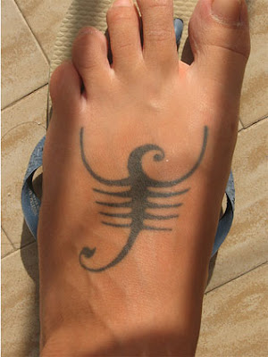 Maori facial tattoo 'Ta Moko' Scorpio Sign Tattoo on the foot.