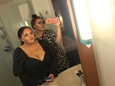 me in a leopard print dress and my friend in a black corset top