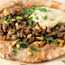 Flat breads topped with lamb and hummus