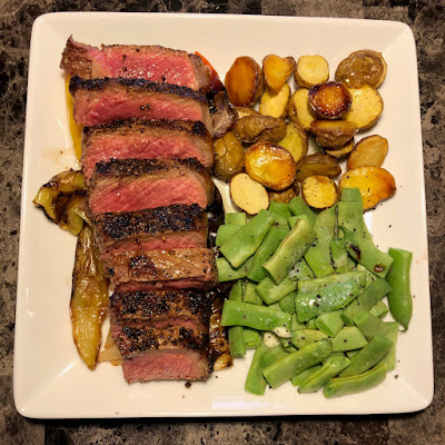 Rare New York strip, roasted peppers, oven roasted potatoes and Italian beans