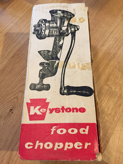 Old-fashioned meat grinder in box