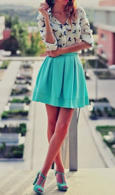 white shirt with blue birds print on it clubbed with aqua green pleated short skirt and sandals