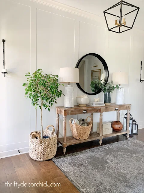foyer with white wall and trim wood table