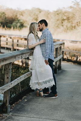 couple kissing on sidewalk