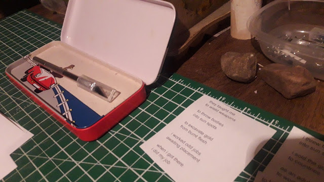 photo of my scalpel and case, and page one of IAN MARTIN's poem laid out in my workshop