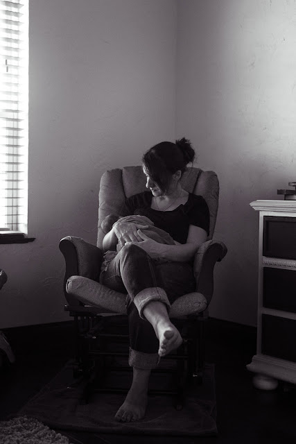 One of the scenes so telling of the baby being a week old...mom is sitting in her rocking chair holding her baby in her arms while nursing.  Taken in their home in Shawnee, OK.