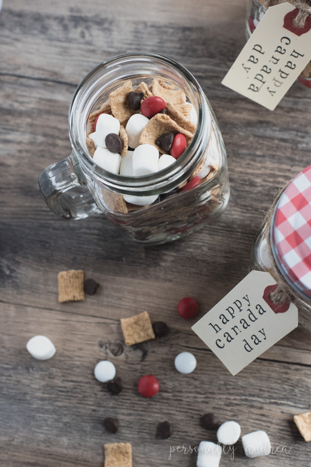 Canada Day S'more Snack Mix in a Mug Party Favor | A fun and festive snack mix packed into a mason jar mug with a stamped shipping tag label.  A party favor to enjoy both now and later. | personallyandrea.com