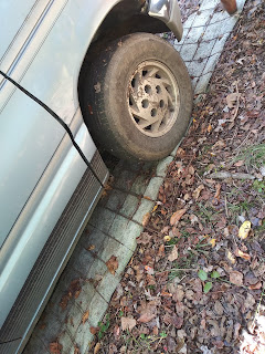 A makeshift driveway to keep the car from sinking into the mud.