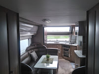 The kitchen with a double fridge is in the front of the caravan.