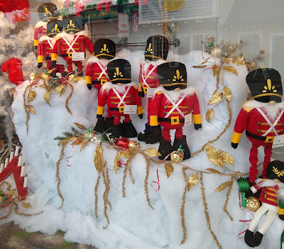 Lots of little stuffed gnomey nutcrackers in a shop window