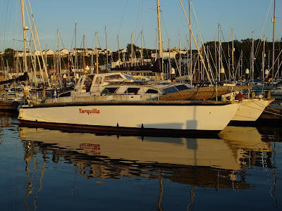 white boat in marina with calm reflective water
