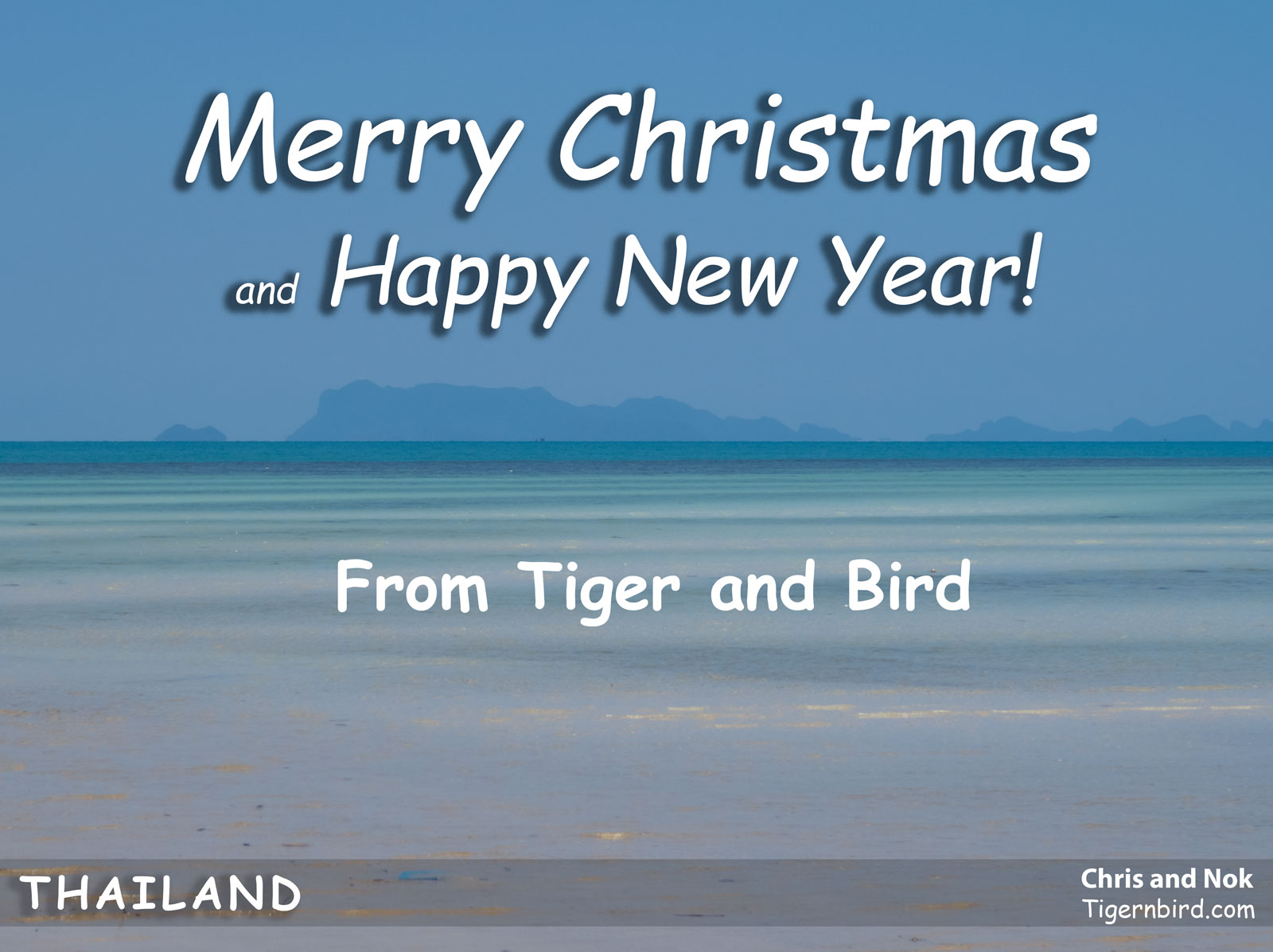 Happy Holidays message on photo of azure waters off of Thai island