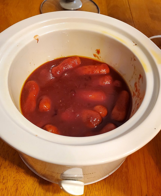 slow cooker filled with bbq mini hotdogs