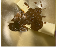 softened butter and raisin puree in a large metal mixing bowl