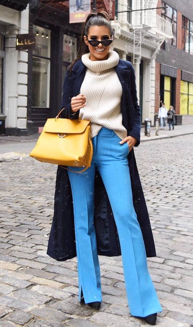 elegant fall outfit idea with a knit sweater : long coat + yellow bag + heels + blue pants