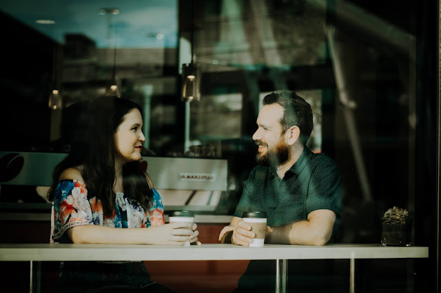 Couple talking with each other at cafe drinking coffee