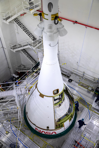 The third of four ogive panels is attached to Orion's launch abort motor as the capsule continues to undergo Artemis 1 flight preps inside the Launch Abort System Facility at NASA's Kennedy Space Center in Florida...on September 1, 2021.