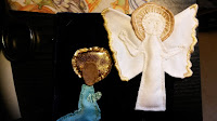 Mary's annunciation with the angel mostly sewn in place and embroidered but Mary unfinished