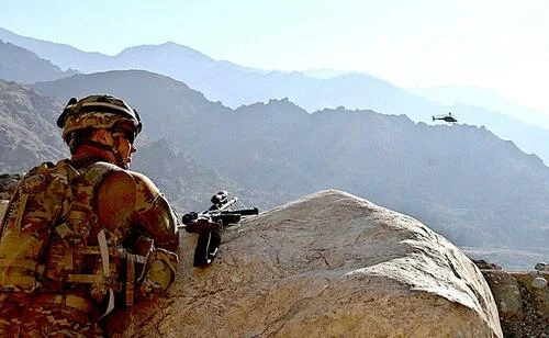 Jan. 1, 2011: U.S. soldier watching as a helicopter provides cover to an explosive ordnance disposal team in Laghman Province, Afghanistan. US Army image