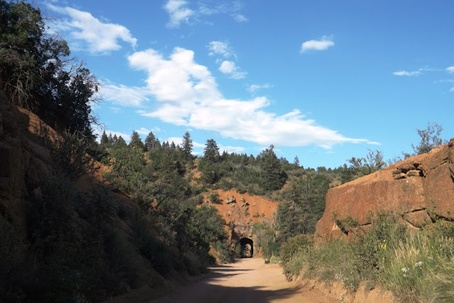 Cheyenne Mountain State Park is located in Colorado Springs. As you may have noticed, Americans are called " park " any place designated for recreation. And this, like the park, located on one of the local mountains. Gore is refined, over 20 km for walking and cycling. For lovers of extreme sports there is a territory with a sign warning of the dangerous area.   Exceptionally clean air and uphill is not only the " intoxicating " but it makes breathing more often. The higher you climb, the harder it is to breathe faster and get tired  That much important for the whole area of the park are benches for rest and even a toilet.    At the entrance to the park hanging map, and anyone can point out where he came from. I was very surprised that in Russia were designated only Moscow and St. Petersburg. Although only lives in Colorado Springs, a lot of Russian ... Ah, Russian, boasting that generous, and spared themselves the dollar on push pin. It's a shame I felt. I wanted to also specify Togliatti on the map. John pointed his hometown.     In a local shop to buy souvenirs and even 24-karat gold for $ 8. Or try to find their own semi-precious stones and gold. It's enough to buy a bottle for $ 2, and imagine that we prospectors for gold mining source .  Gold of course we do not deposit but the interesting stones have collected.  Conversely, we came back here after such tunnels in the mountains. The tunnels are very narrow. Through them can pass only one car. Therefore, when entering a tunnel, ensure that the meeting does not go car.  Cheyenne Mountain State Park расположен в г. Колорадо Спринг.  Как вы уже заметили, Американцы  называют «парком» любое место, предназначенное для отдыха.  И этот, типа парк, расположен на одной из местных гор. Гора облагорожена, на протяжении 20 км для прогулок пешком и на велосипеде. Для любителей экстрима есть территория с предупредительной табличкой об опасном участке.    Необыкновенно чистый воздух и подъём в гору не только «опьяняет» но и заставляет дышать чаще. Чем выше поднимаешься- тем тяжелее дышать и быстрее устаешь    Что немало важно на всей территория парка стоят скамейки для отдыха и даже есть туалет.    У входа в парк висят карты, и каждый желающий может указать, откуда он приехал. Меня сильно удивило, что из России были обозначены только Москва и Санкт-Петербург. Хотя только в  Колорадо Спрингс живет очень много русских…  Эх, русские, хвастаетесь, что щедрые, а сами пожалели доллар на булавочку. Обидно мне стало. Захотелось тоже указать город Тольятти на карте. Джон указал свой родной город.     В местном магазинчике можно купить сувениры  и даже золота 24 карата за 8 долларов. Или попытаться самим найти полудрагоценные камни и золото. Для этого достаточно купить бутылочку за 2 доллара и представить что мы старатели на золото добывающем источнике.   Золота мы, конечно не намыли. Но красивые камушки насобирали.   Обратно мы возвращались через вот такие туннели в горах. Туннели очень узкие. Через них может проехать только одна машина. Поэтому при въезде в туннель необходимо убедиться, что на встречу не едет машина.