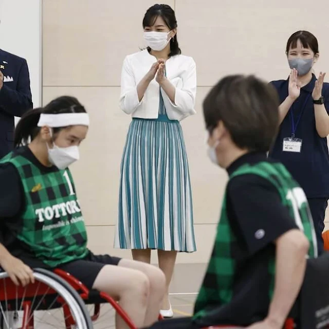 Princess Kako wore a short sleeve pleated white green striped dress and white wool jacket. She wore white leather pumps